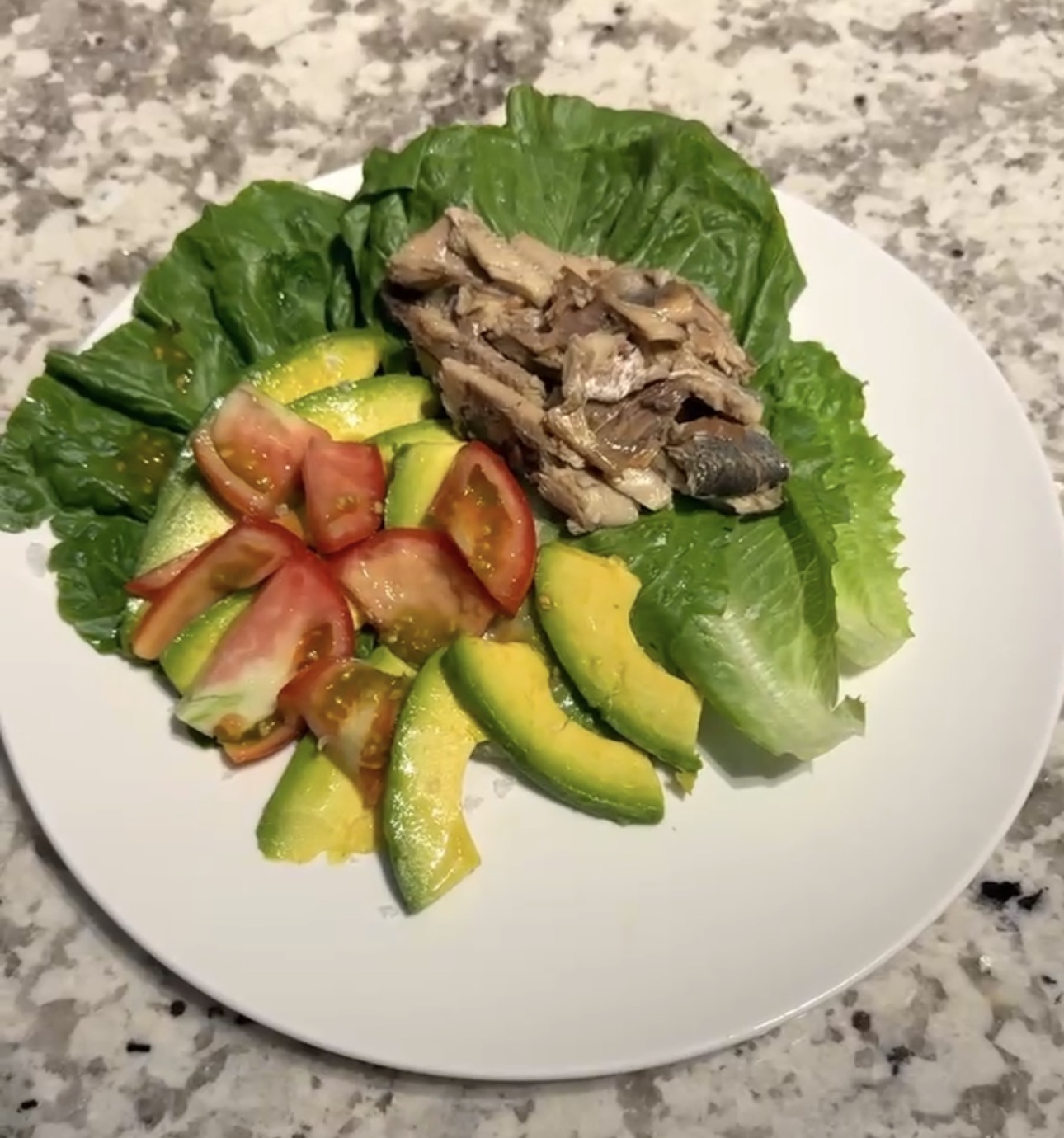 Clean whole food plate with mackerel, avocado, tomato and lettuce