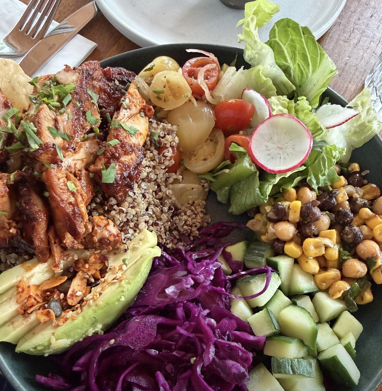 Colorful whole food bowl with chicken, quinoa and vegetables